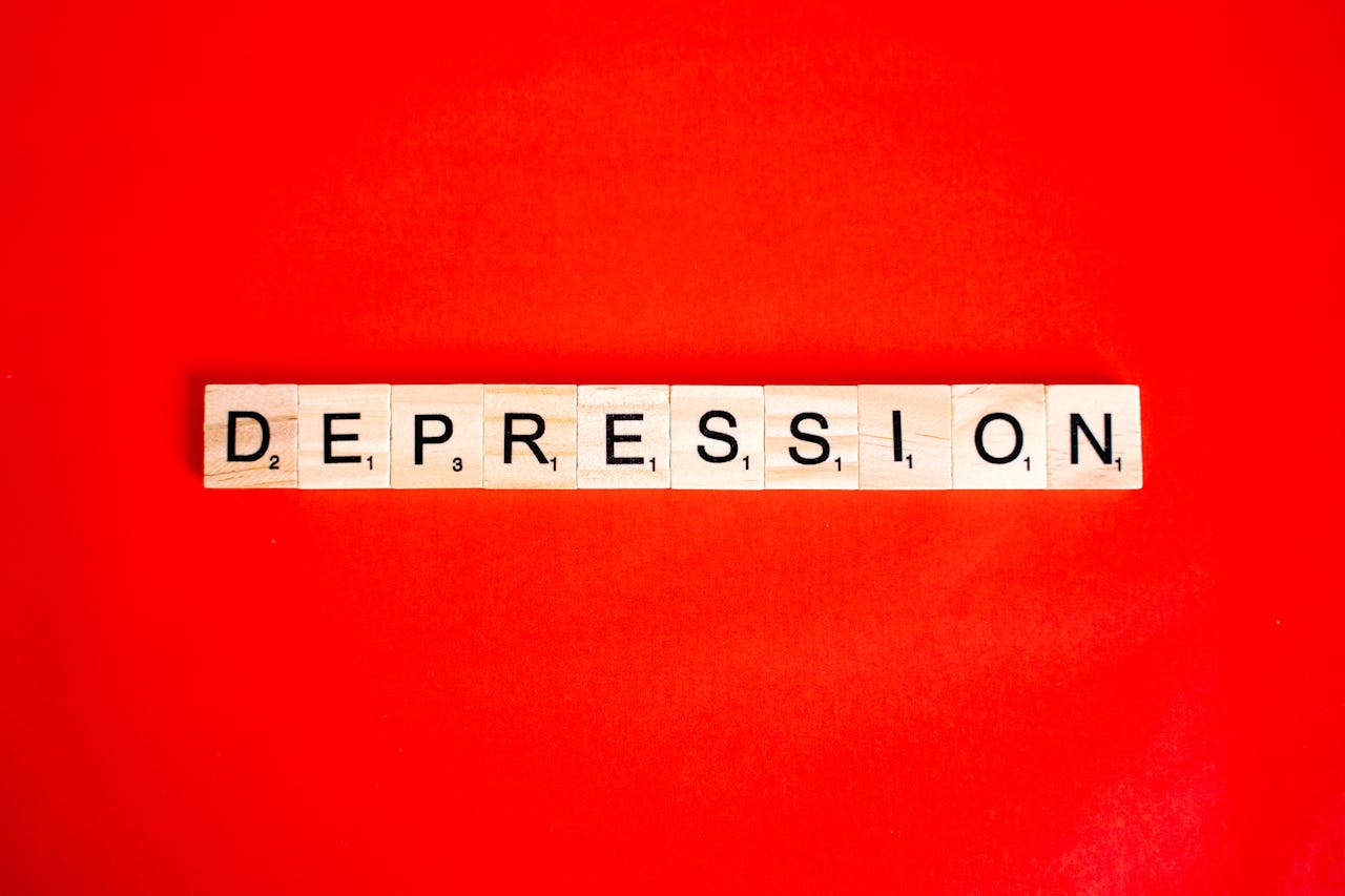 Crafting Captivating Headlines: Your awesome post title goes here Word depression spelled with letter tiles on vibrant red background, highlighting mental health theme.